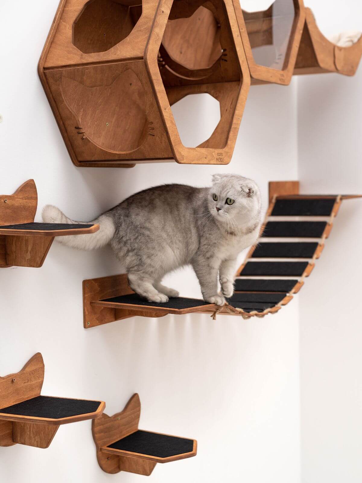 long cat wall bridge covered with black felt made from wood