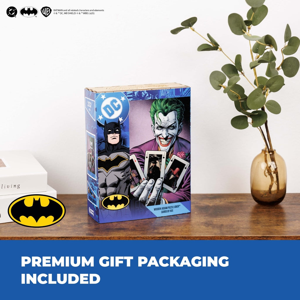 DC Comics Joker action figure packaging on a wooden surface with Batman logo and 'Premium Gift Packaging Included' text.