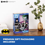 DC Comics Joker action figure packaging on a wooden surface with Batman logo and 'Premium Gift Packaging Included' text.