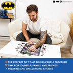 Man assembling a puzzle on a coffee table with Batman logo in the corner