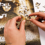 Mosaic art of a person wearing a fur hat and green coat with a pipe.