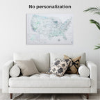 White couch with decorative pillows against a wall with a world map poster.