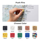 Hand using push pins on a map with color options displayed below.
