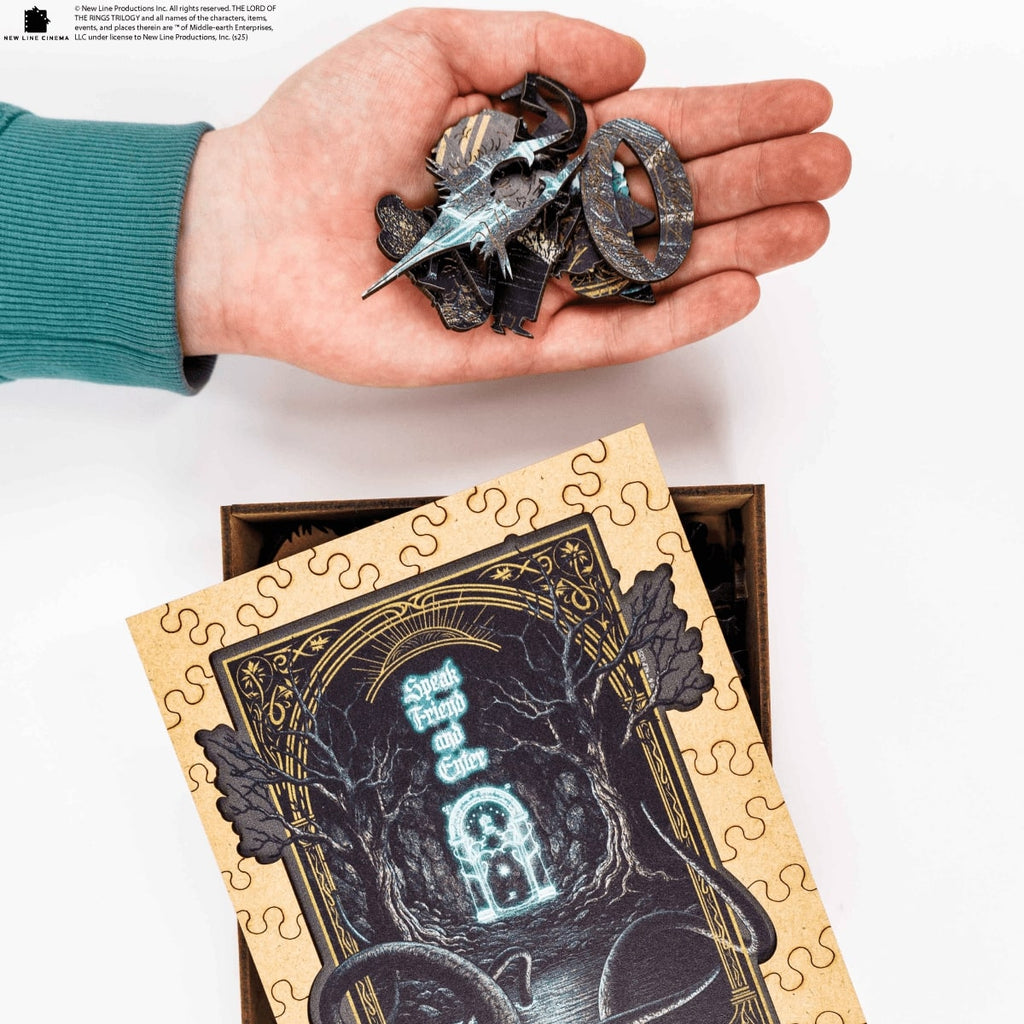 Hand holding puzzle pieces above a partially completed puzzle with a decorative cover.