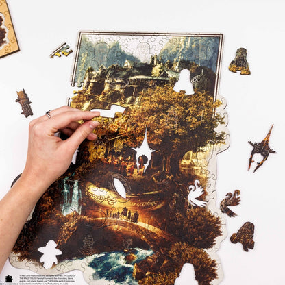 Living room with a gray sofa, brown chair, and a wall art piece depicting a scenic landscape.