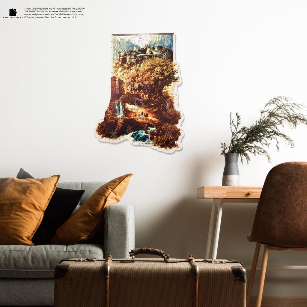 Living room with a gray sofa, brown chair, and a wall art piece depicting a scenic landscape.