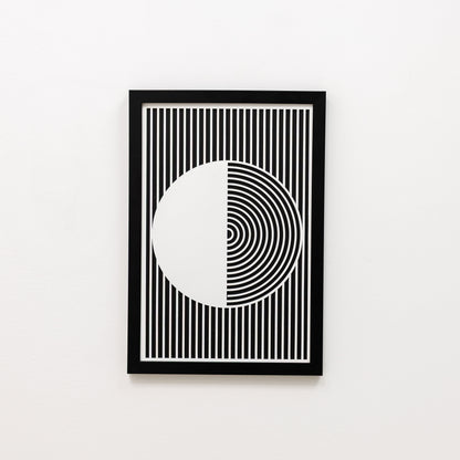 Framed black and white geometric art print on a white wall