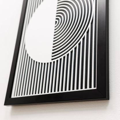 Framed black and white abstract art piece on a white background