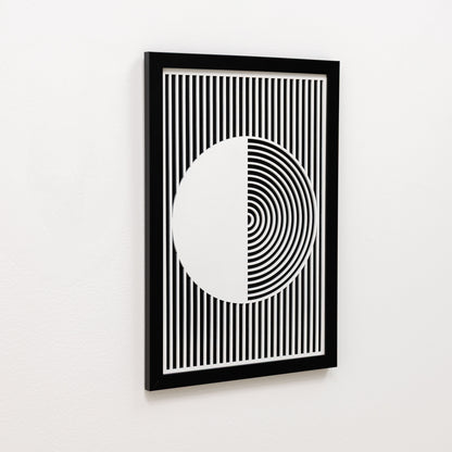 Framed black and white geometric art print on a white wall