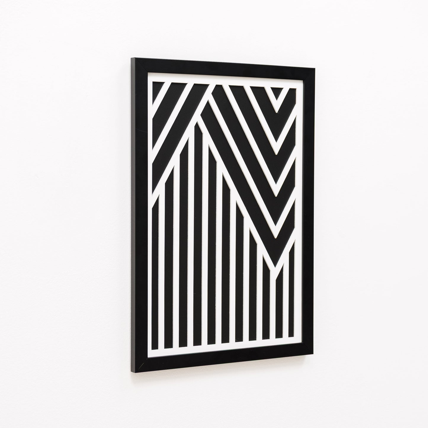 Framed black and white geometric art piece on a white background