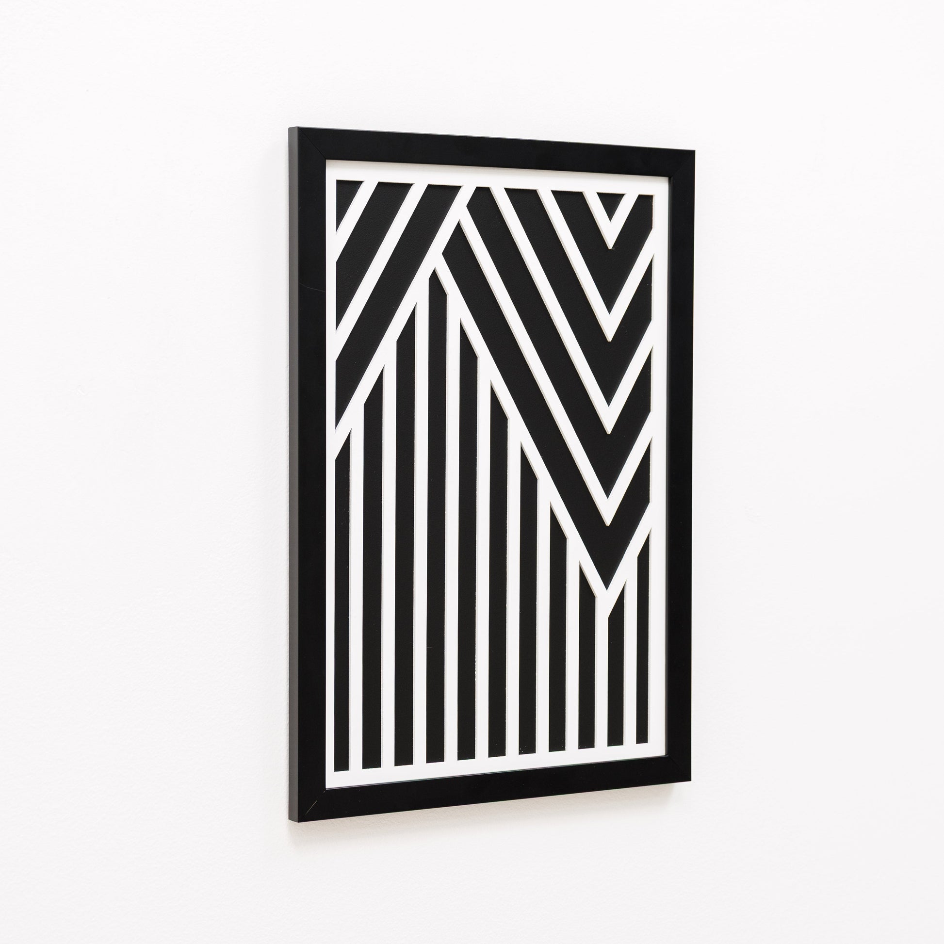 Framed black and white geometric art piece on a white background