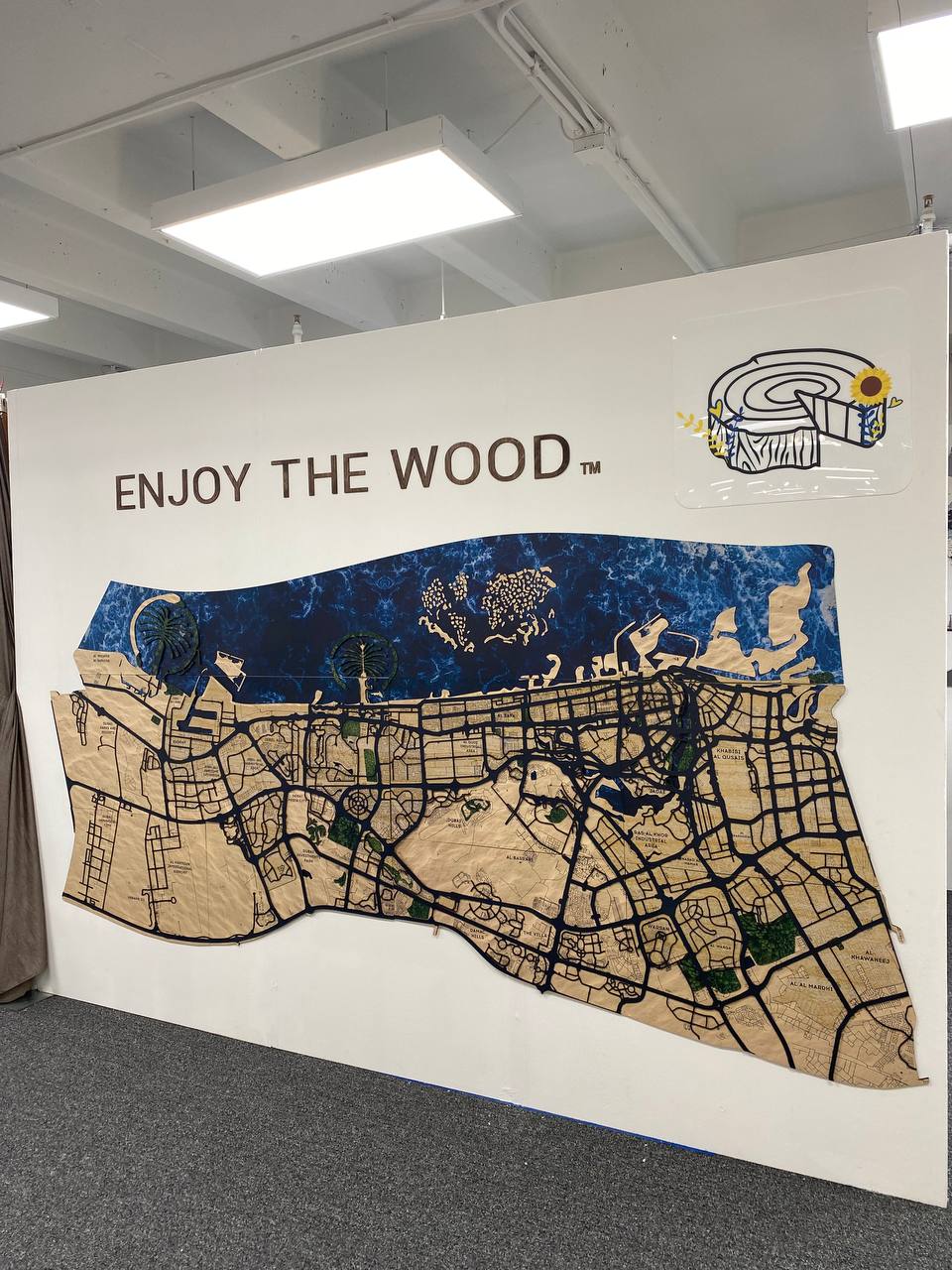 Wall with 'Enjoy the Wood' branding and a map design.