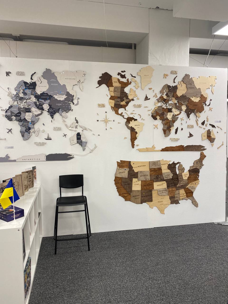 World map on a wall with a chair in front of it in an office setting