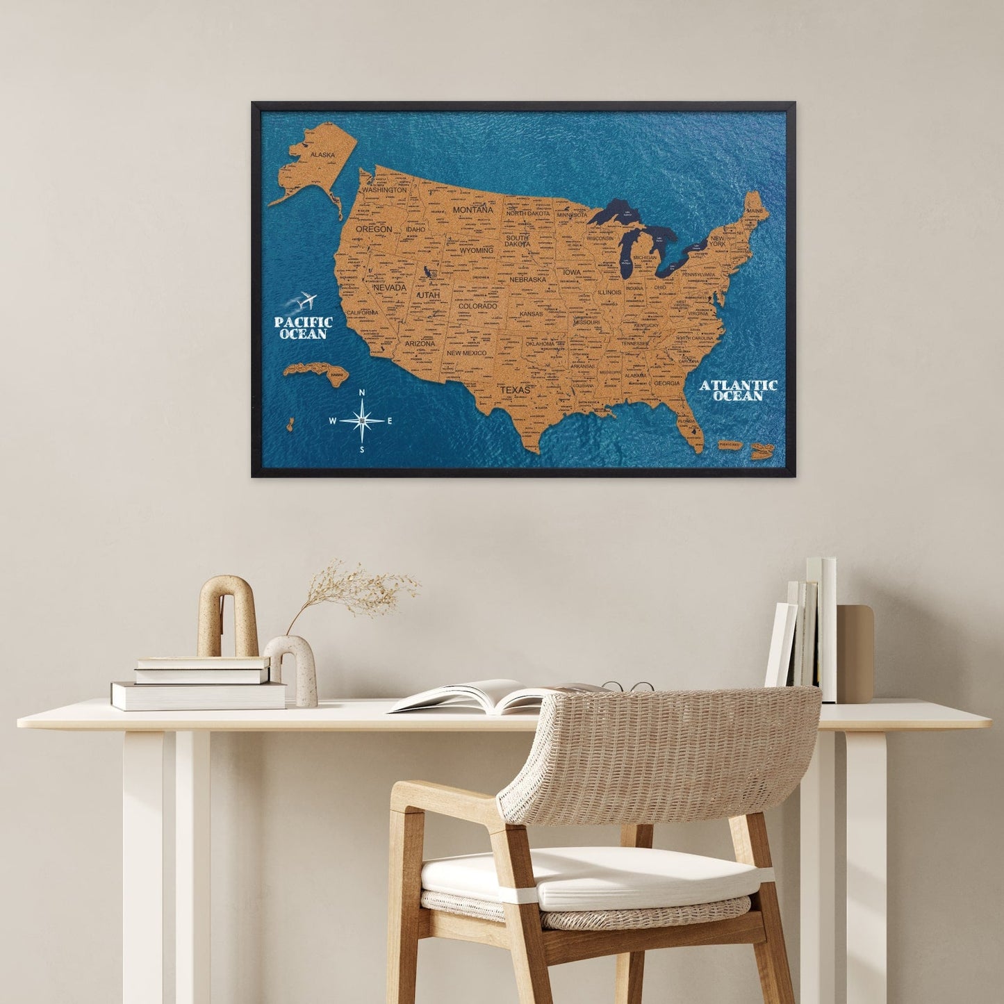 Framed map of the United States on a wall above a desk with a chair.