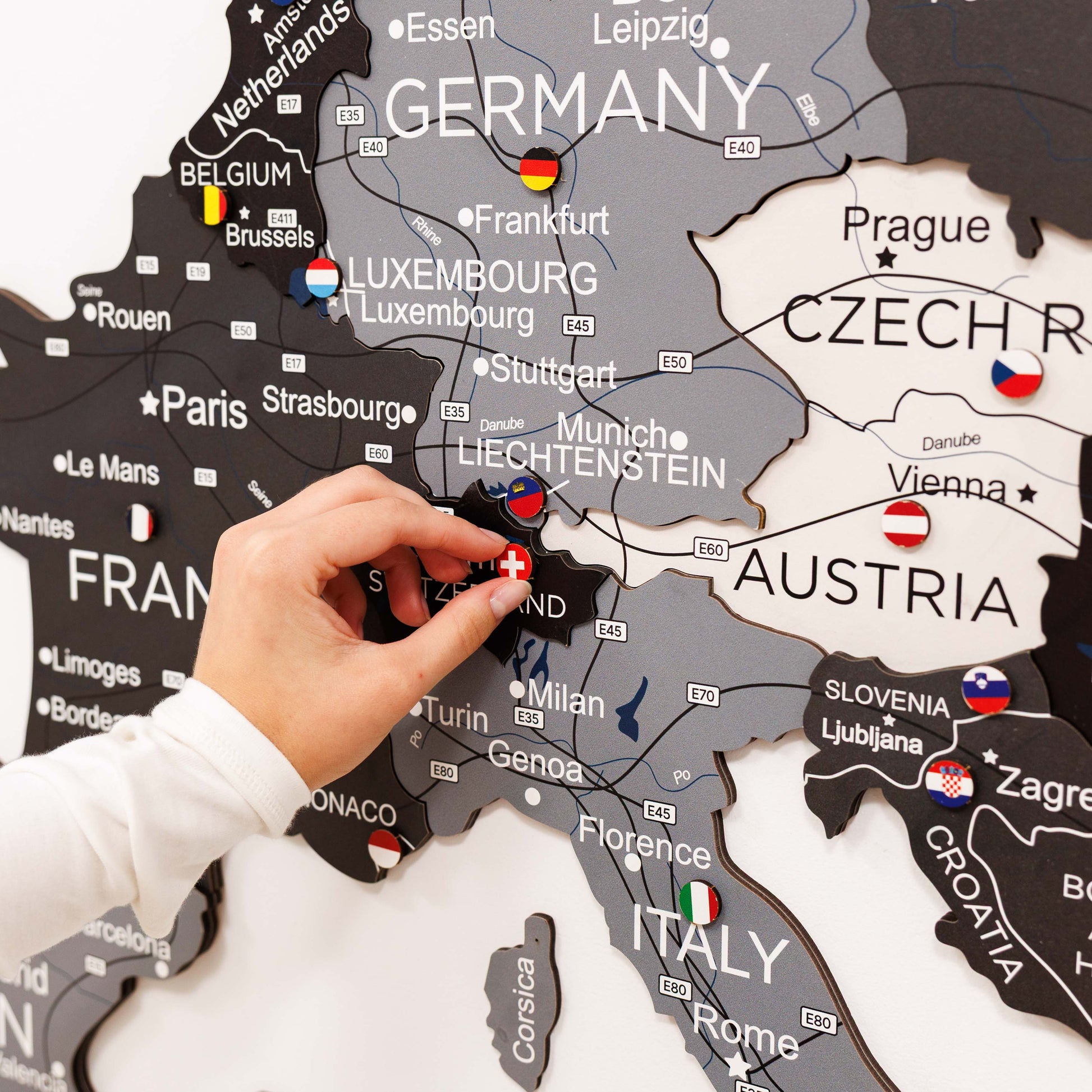 Map of Europe with a hand placing a flag pin on Germany