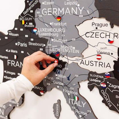 Map of Europe with a hand placing a flag pin on Germany