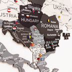 Woman interacting with a map of Europe on a wall, highlighting Poland.