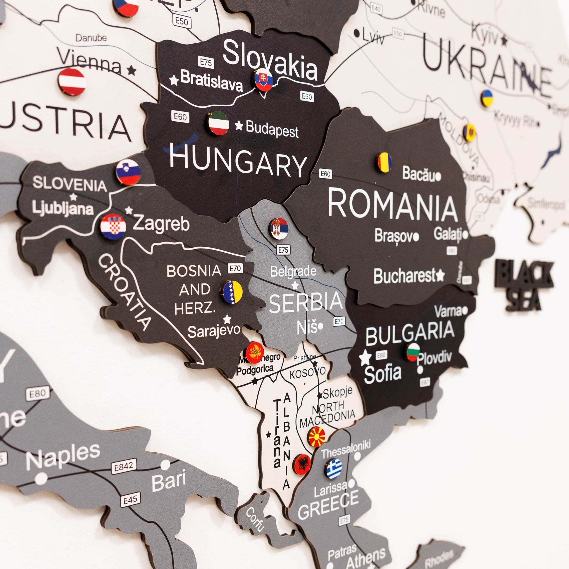 Woman interacting with a map of Europe on a wall, highlighting Poland.