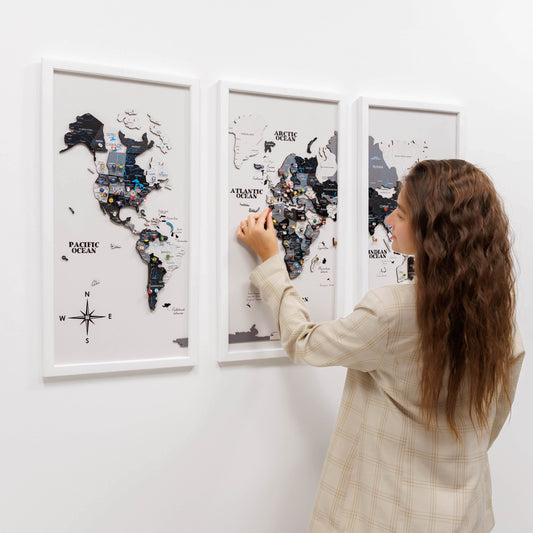 Woman interacting with a world map on a wall