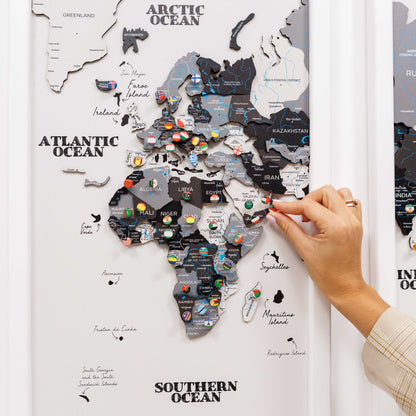 Map of Africa with pins attached, hand interacting with the map