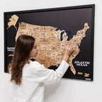 Woman interacting with a framed map of the United States on a wall