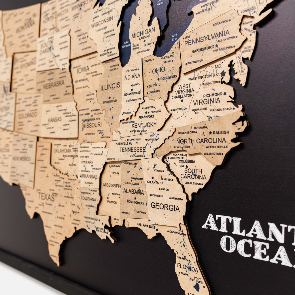 Wooden map of the United States with state names on a black background