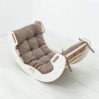Rocker chair with brown cushion on a white floor