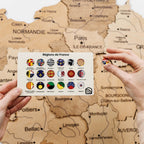 Map of France with regions displayed on a card held over it