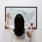 Person interacting with a map of the United States on a wall