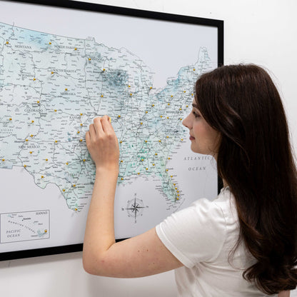 Woman looking at a map of the United States on a wall
