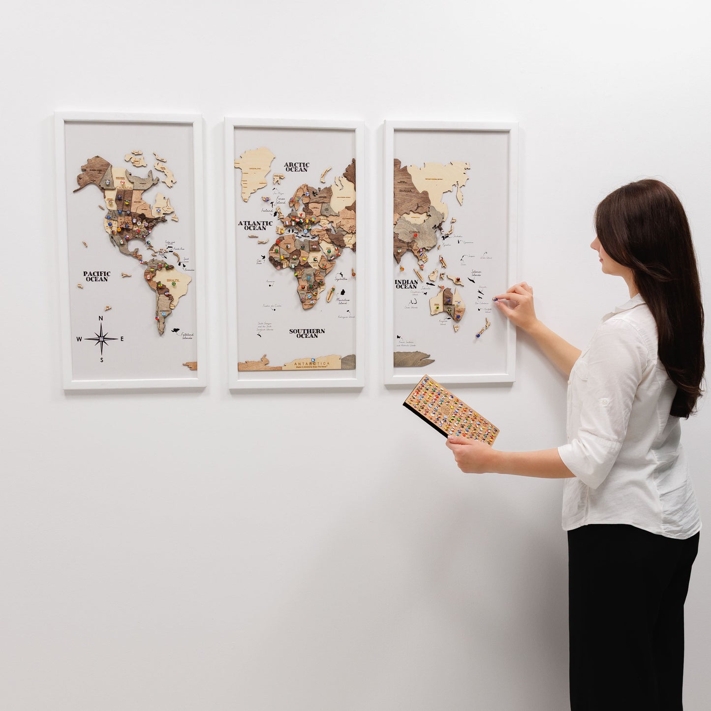 Woman interacting with a world map on a wall