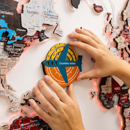 Map with a 'Countries visited' counter shaped like an airplane, held by hands on a world map background.