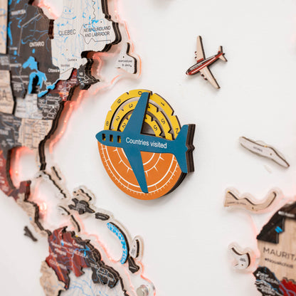 Map of the world with a decorative travel badge and airplane figurines on a light background