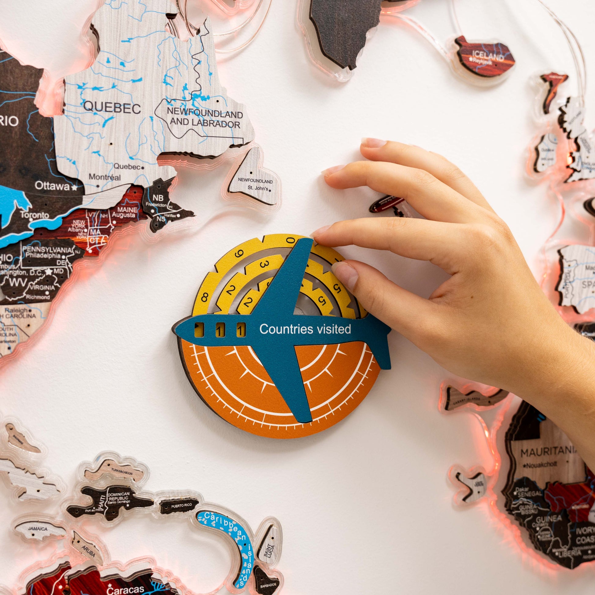 Map of Canada with a 'Countries visited' tracker and hands interacting with it.