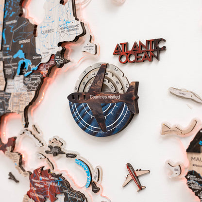 Map of the world with travel-themed decorations including a compass and airplane on a white background.