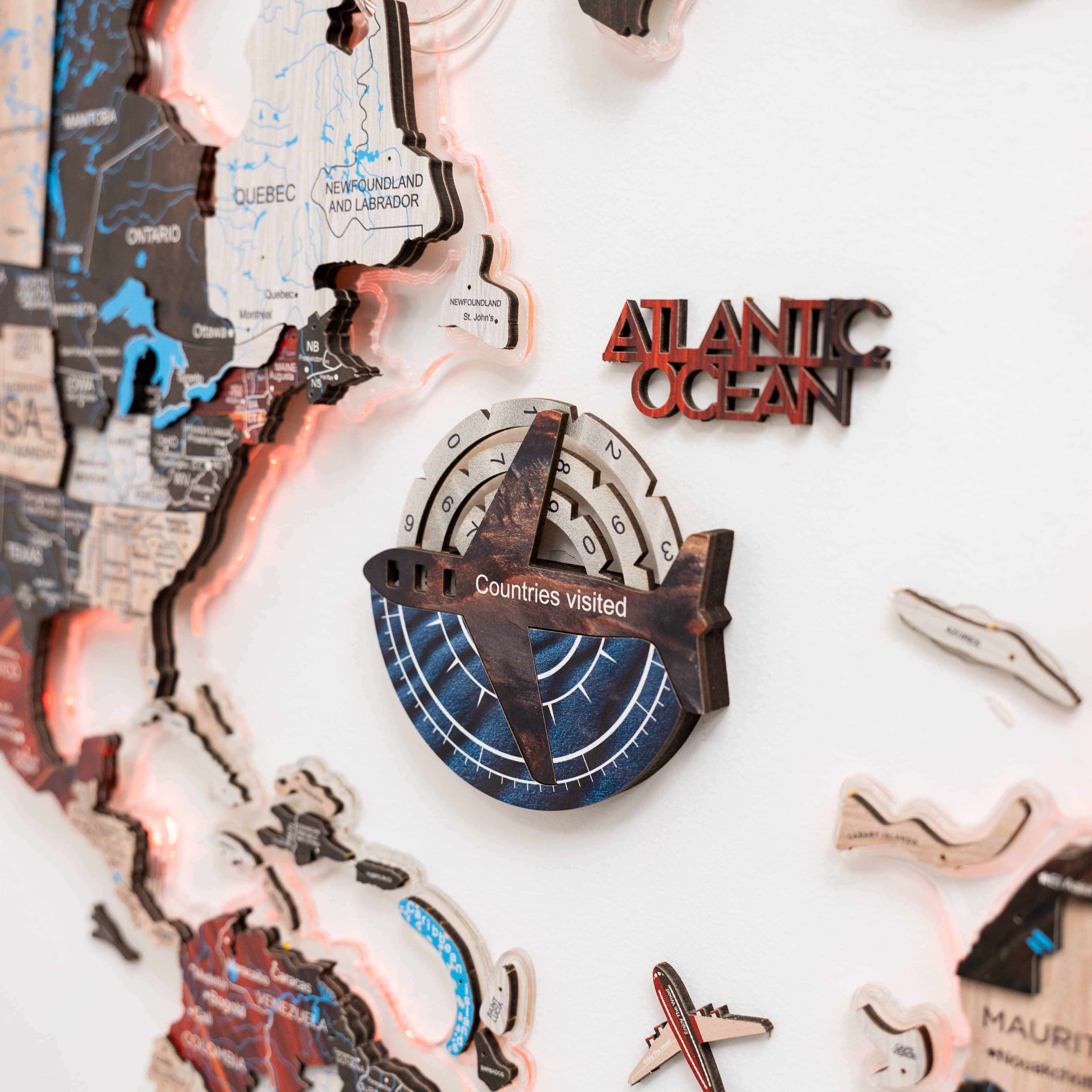 Wooden map with cut-out shapes of countries visited, featuring 'Atlantic Ocean' and 'Countries Visited' text.