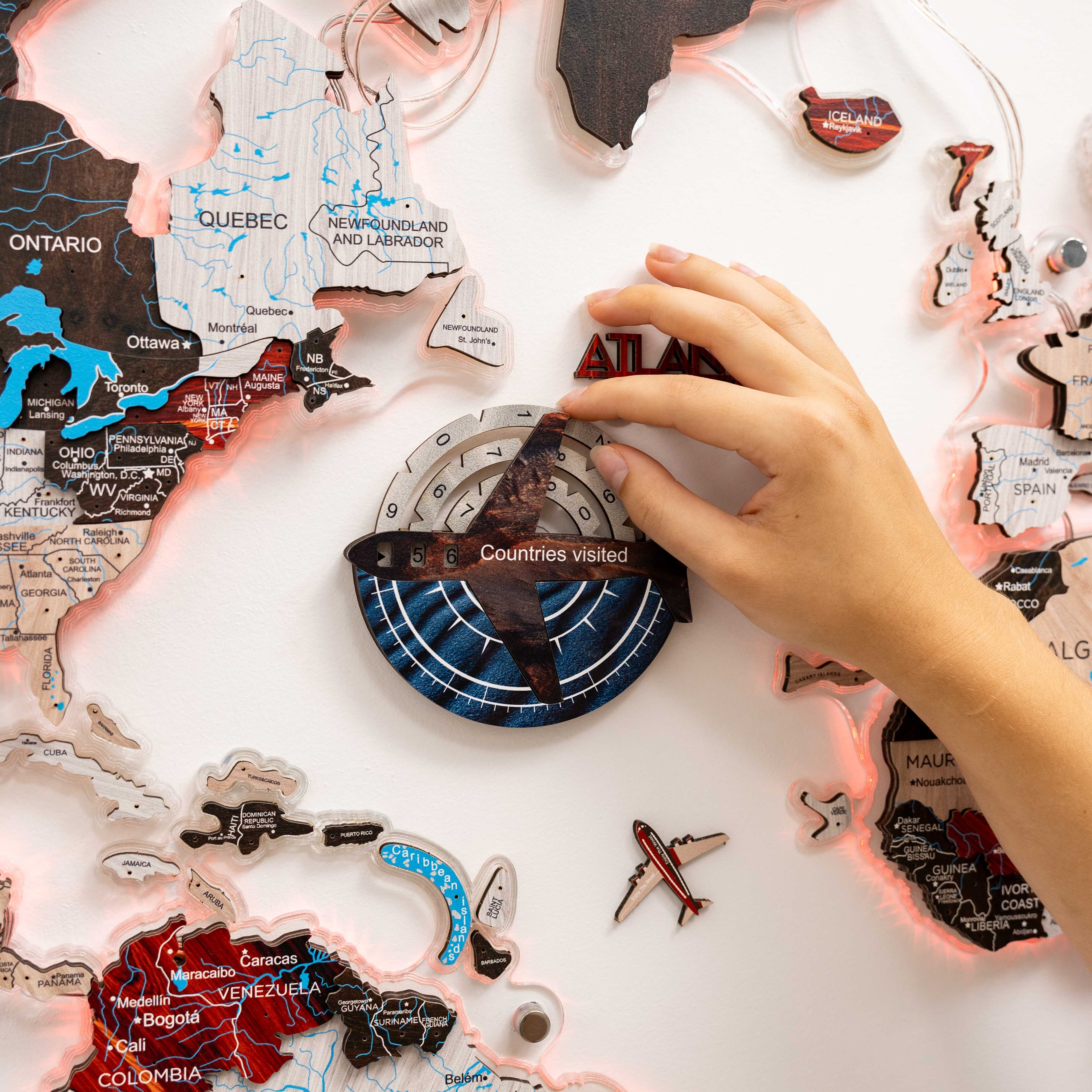 Map of Canada with travel stickers and a compass on a white surface