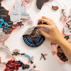 Map of Canada with travel stickers and a compass on a white surface
