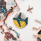 Decorative item with airplane design and 'Countries visited' text on a world map background