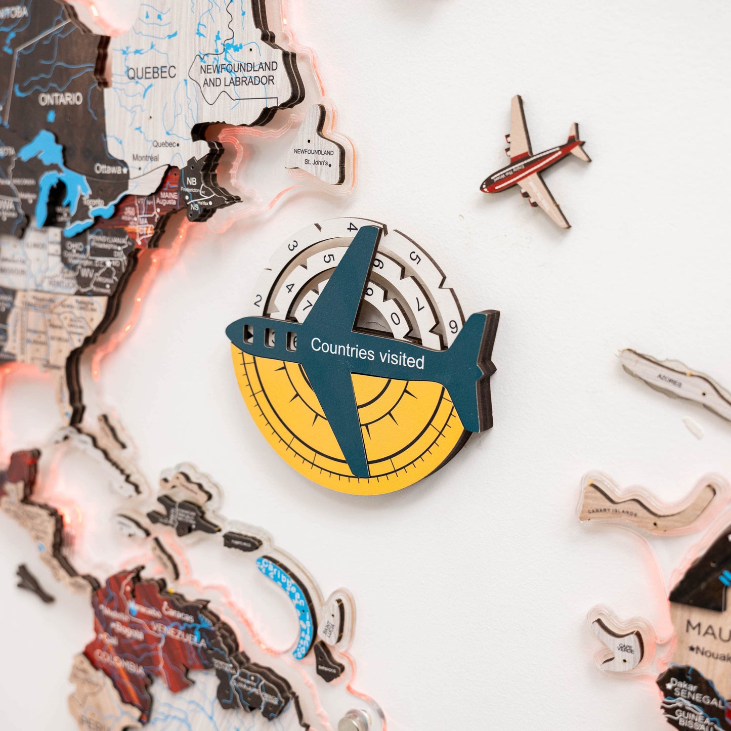 Decorative item with airplane design and 'Countries visited' text on a world map background