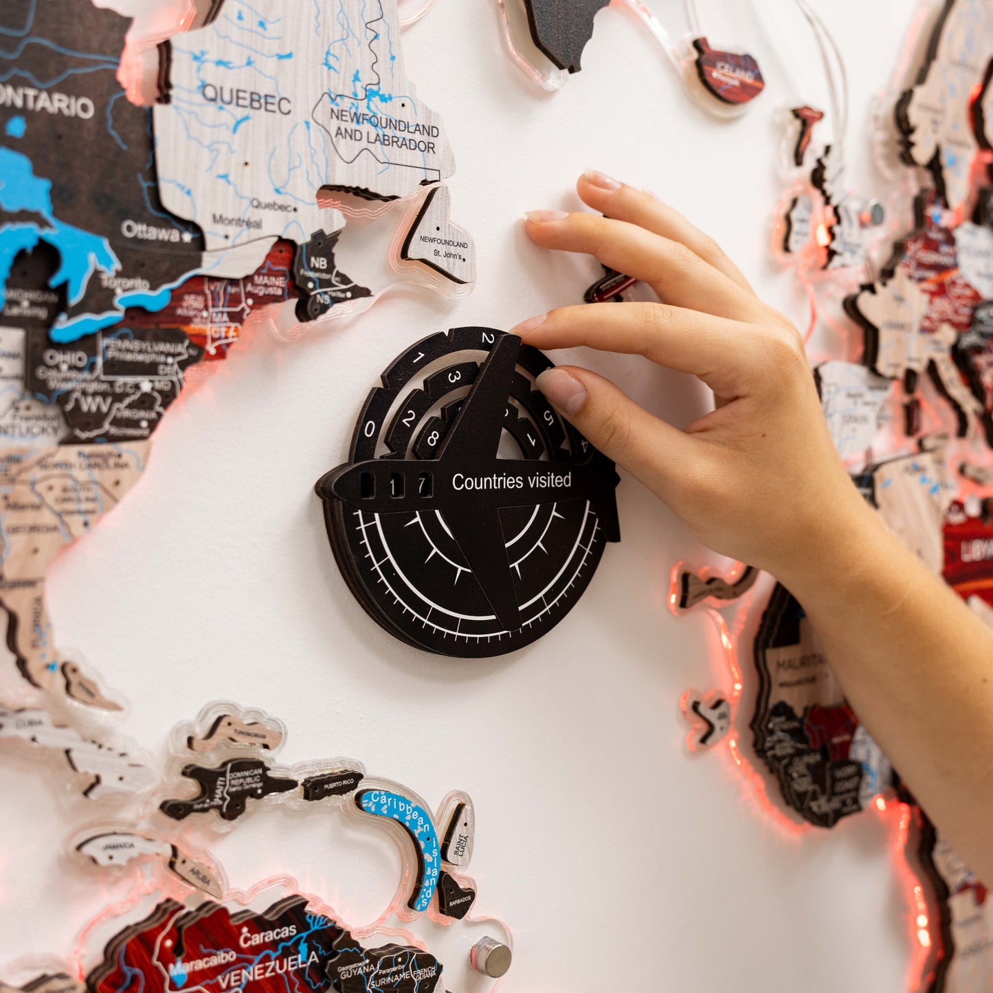 Person interacting with a travel-themed decorative item featuring world map designs.