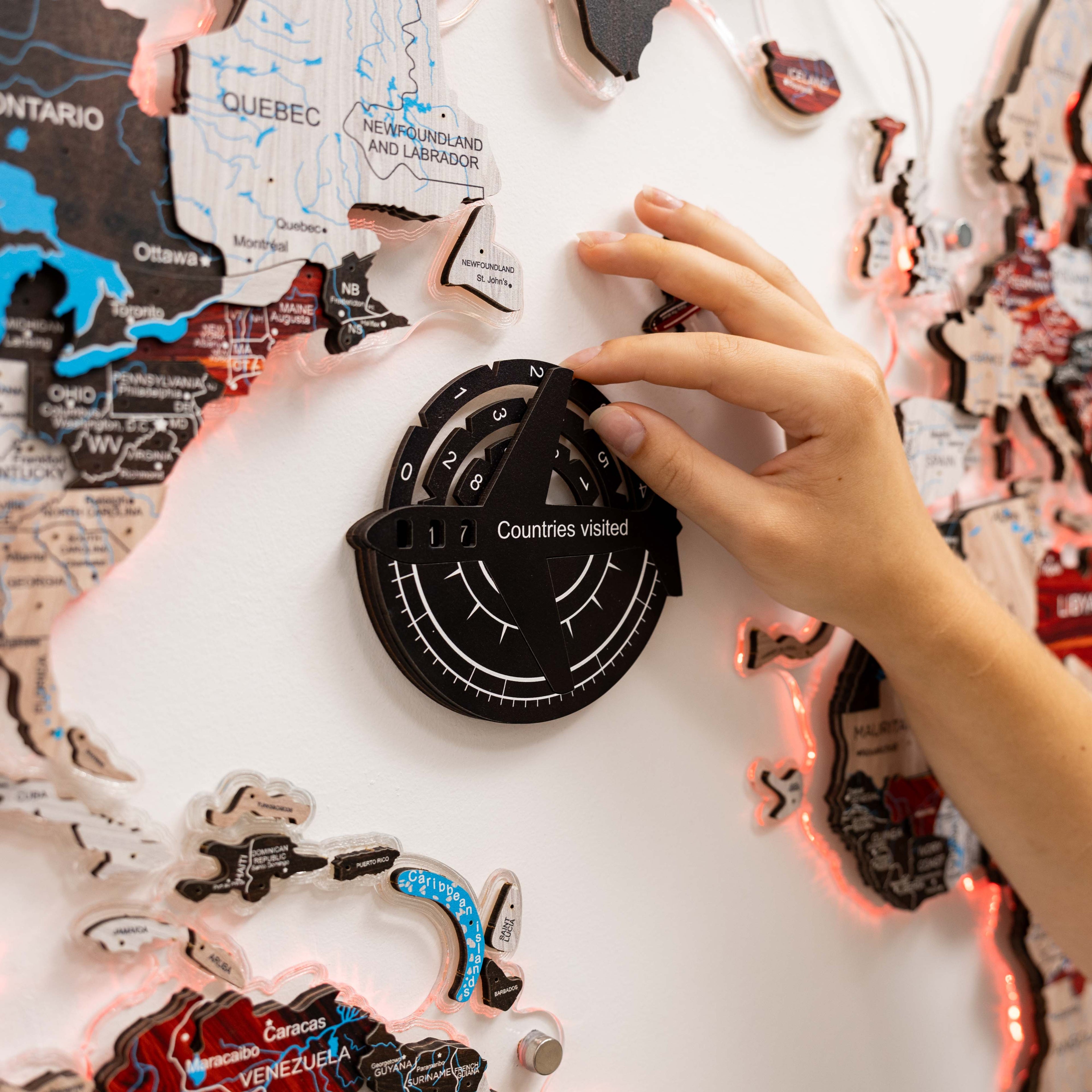 Person interacting with a travel-themed decorative item featuring world map designs.