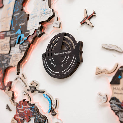 Decorative wall clock with world map design and airplane symbol on a white background