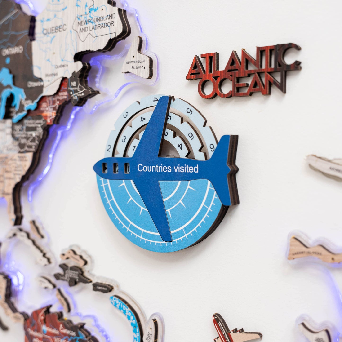 Decorative wall art with a map of Canada, 'Atlantic Ocean' text, and airplane symbol indicating 'Countries visited'.