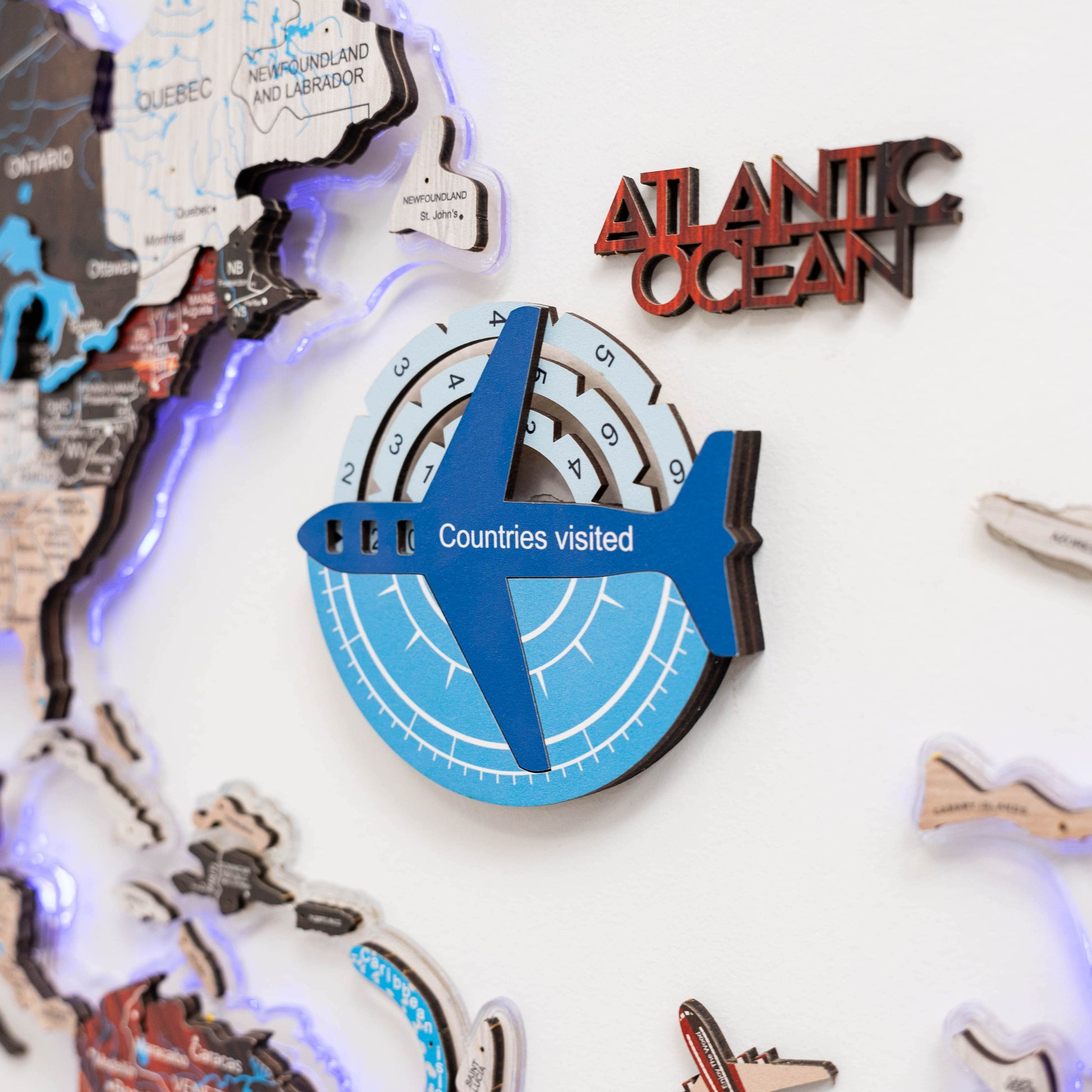 Decorative wall art with a map of Canada, 'Atlantic Ocean' text, and airplane symbol indicating 'Countries visited'.