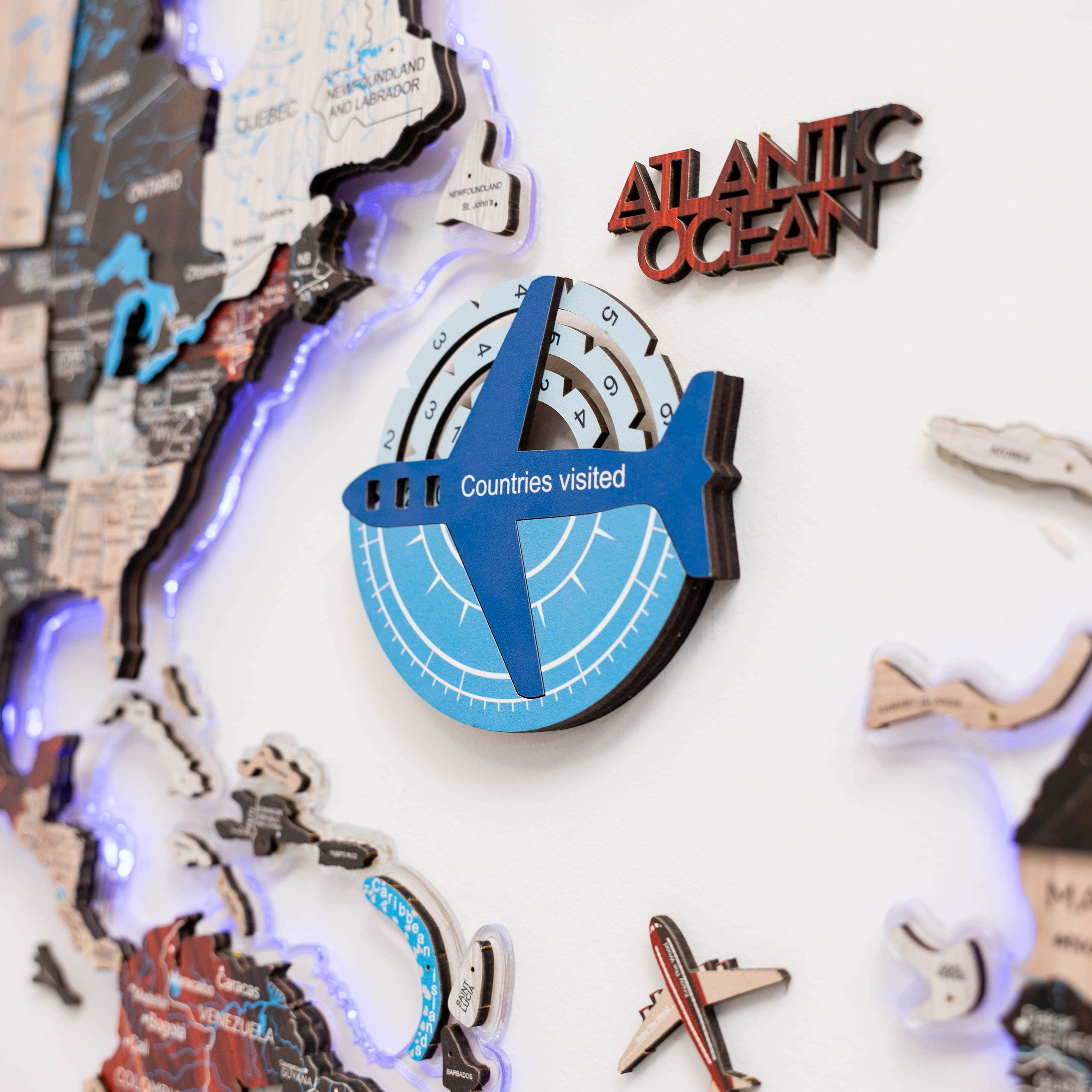 Decorative item with airplane design and 'Atlantic Ocean' text on a map-themed background