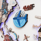 Decorative item with airplane design and 'Atlantic Ocean' text on a map-themed background