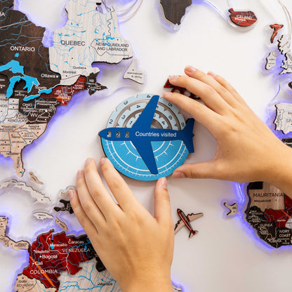 Children's hands interacting with a map of the world and a 'Countries visited' tracker.