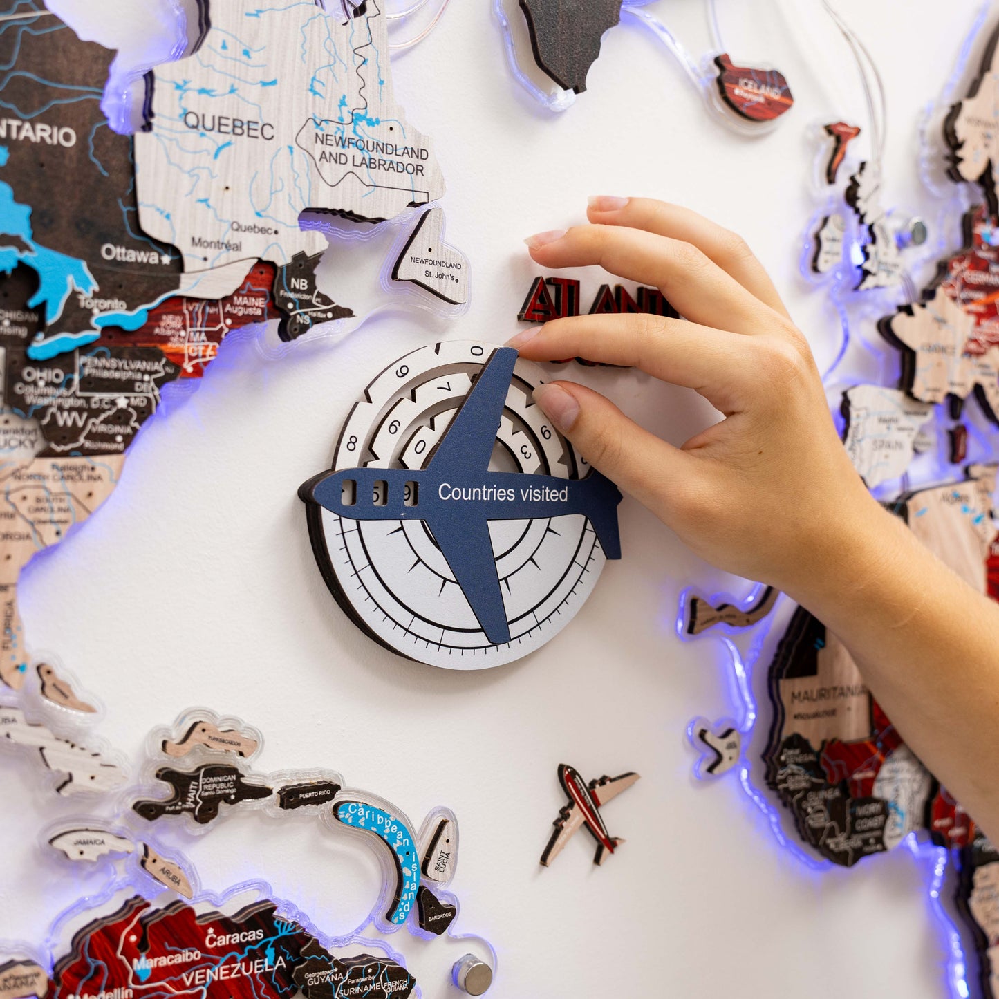 Person interacting with a travel-themed puzzle on a map