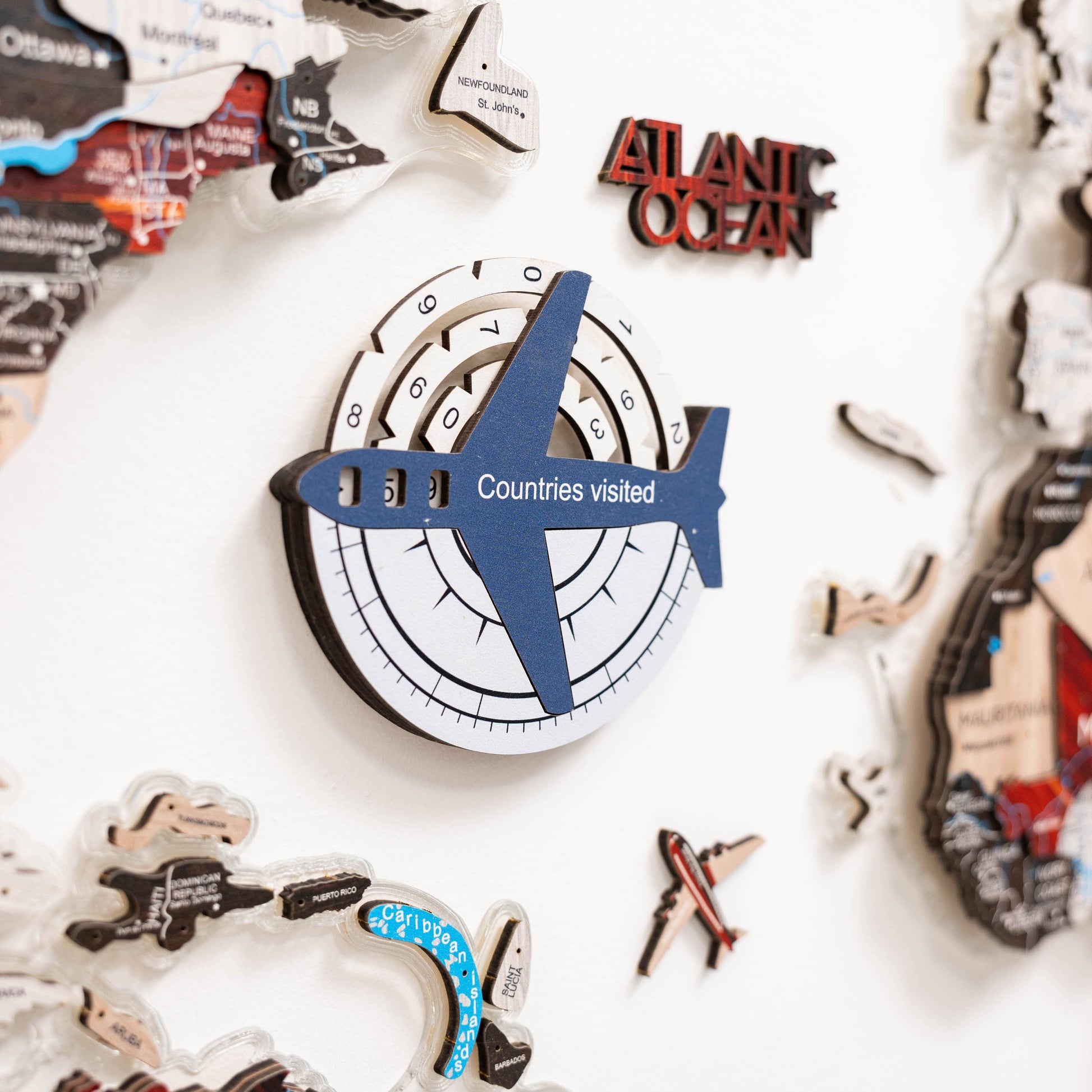 Decorative wall art with an airplane and 'Countries visited' counter on a white background.